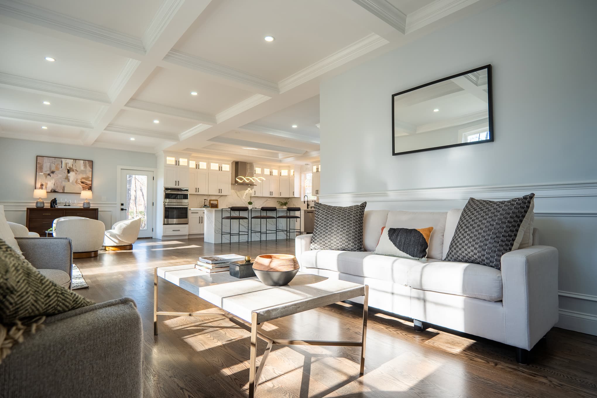 A modern living room featuring a stylish couch and coffee table, showcasing architectural design services.