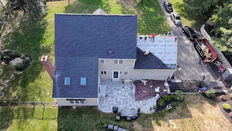 Roofers prepping a roof for a new roof installation on a home.