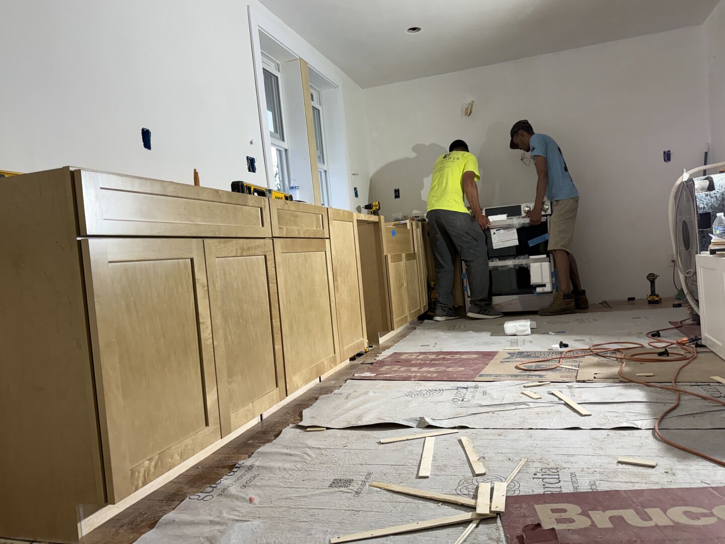 Two kitchen contractors working during a kitchen remodeling project.
